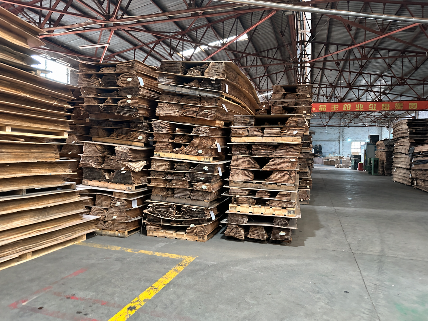 Stacks of wood veneer stored in the Linyi Duoyuan warehouse